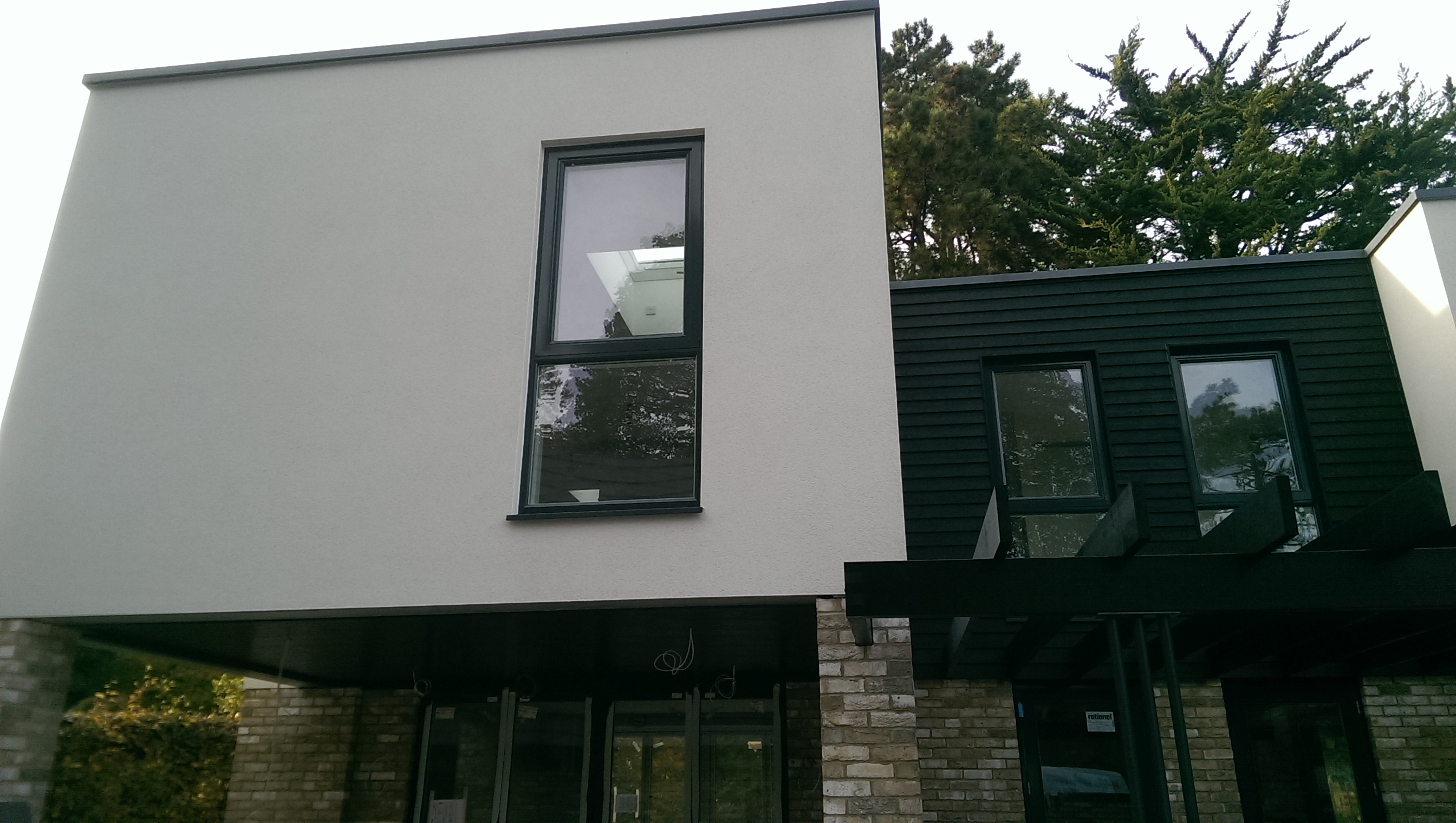 Modern extension with smooth render and black cladding