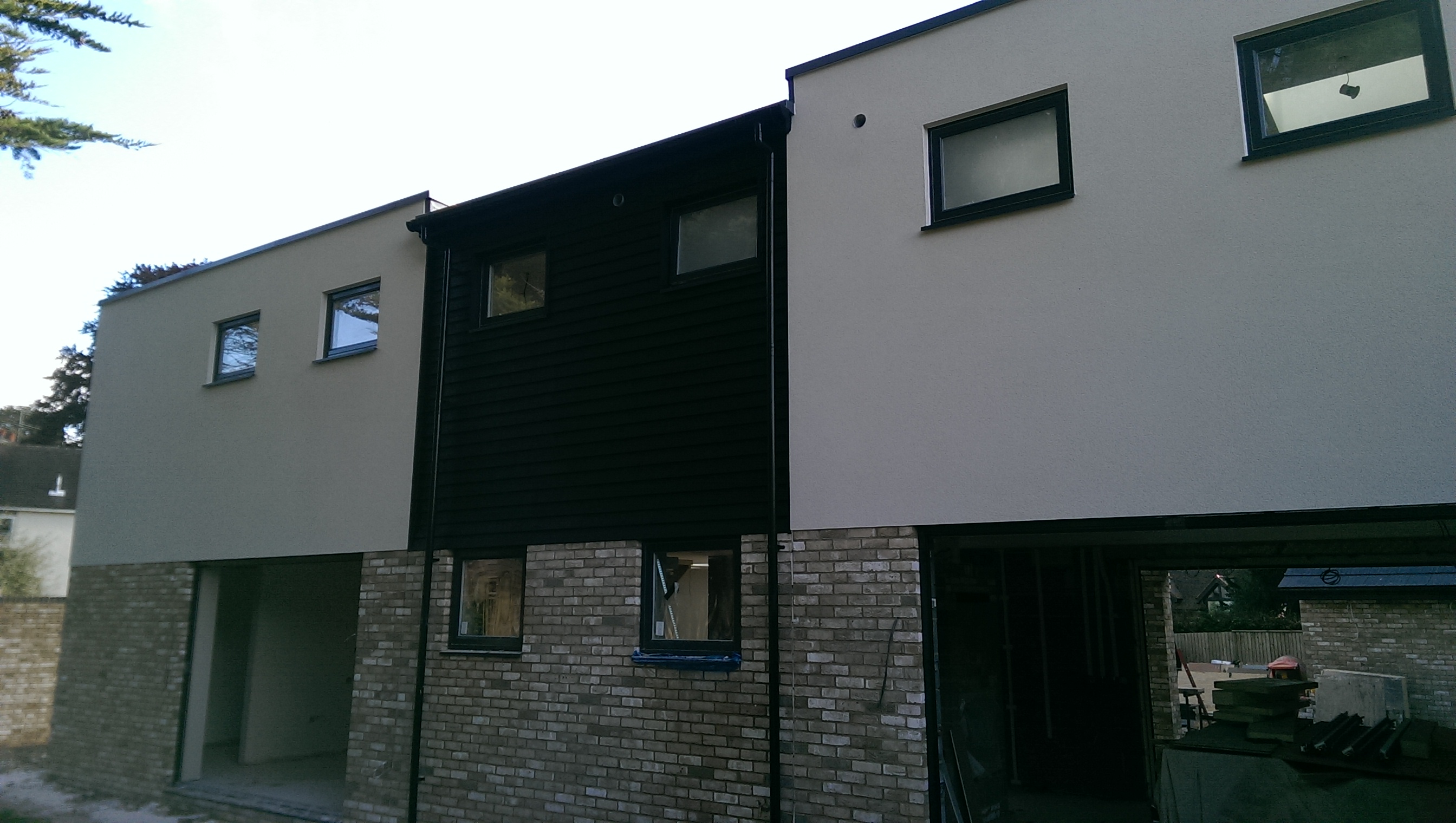 Row of modern homes with grey render panels