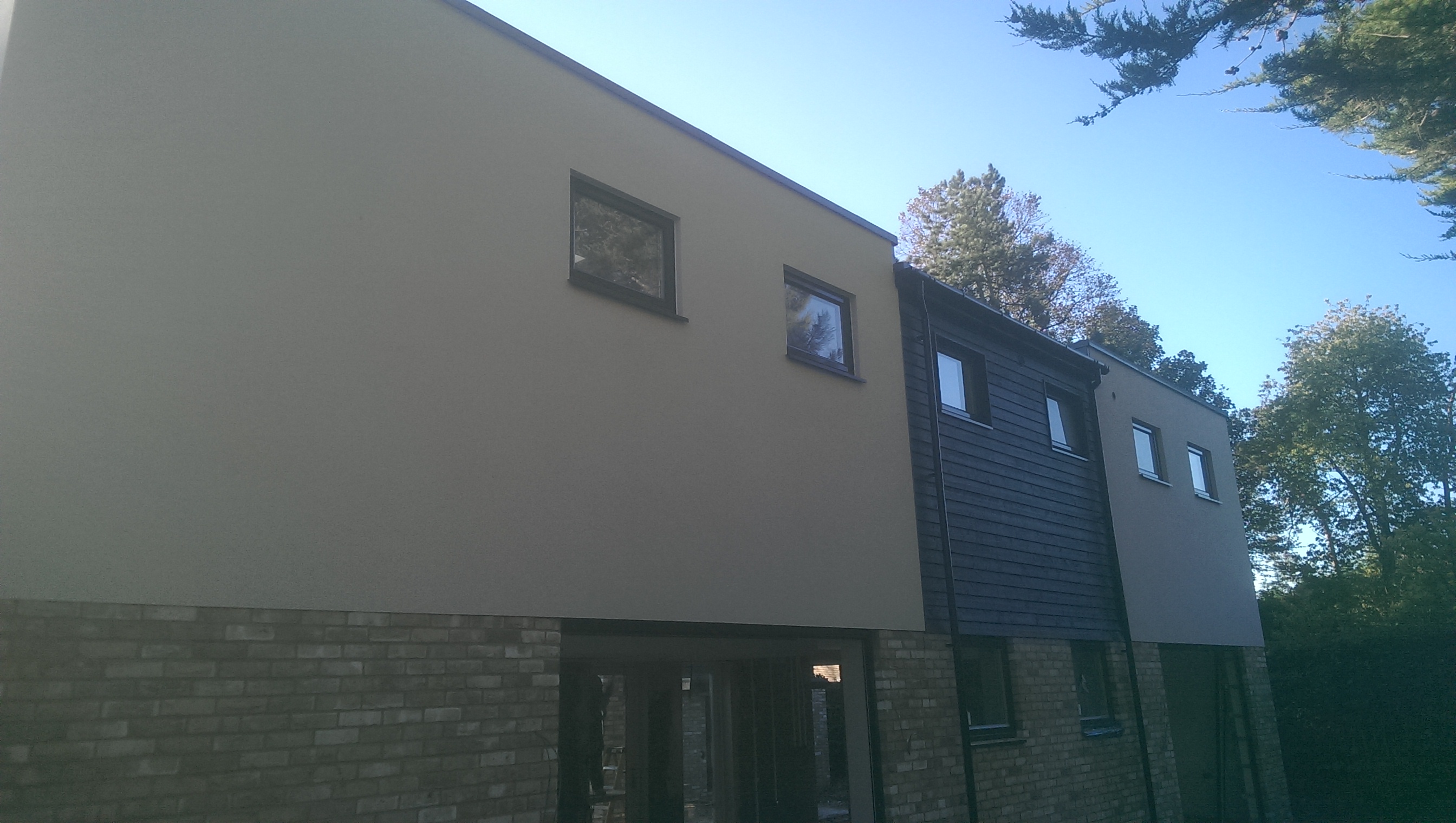Grey rendered upper storey on a new development