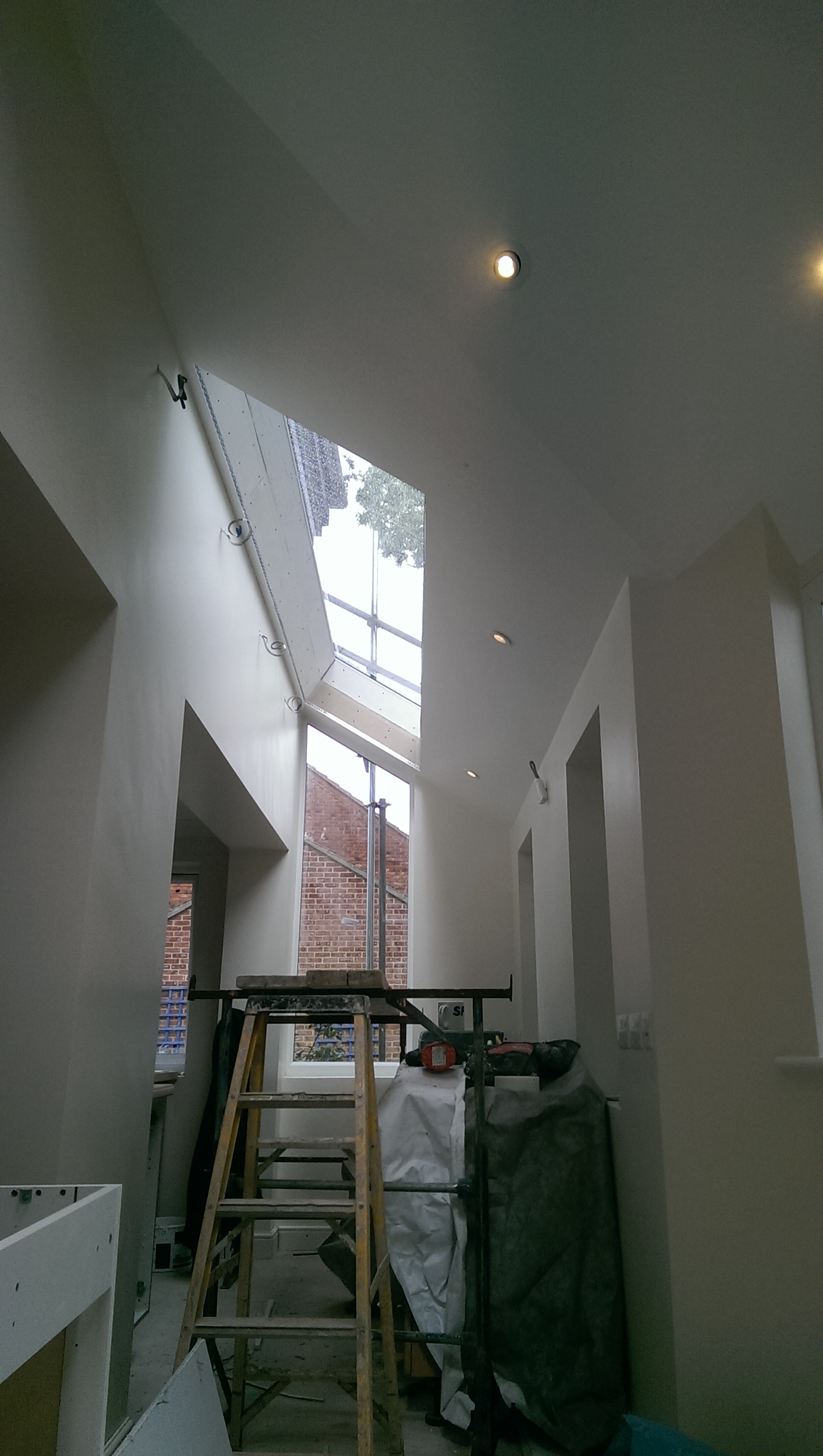 Freshly plastered stairwell under a rooflight